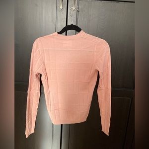 Women’s pink sweater.